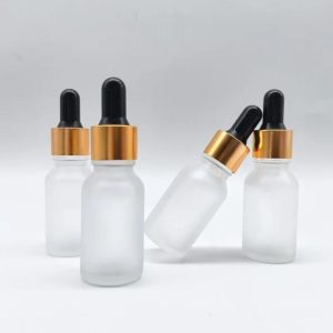 Flacon compte goutte en verre transparent givré bouchon doré-noir (1)