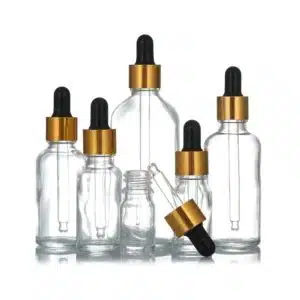 Flacon compte goutte verre transparent bouchon doré-noir (1)