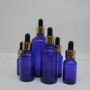 Flacon verre bleu pipette doré noir (1)