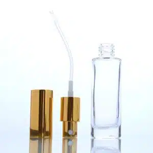Flacon en verre transparent pour parfum avec bouchon spray dorée et épaulement plat emballage cosmetique maroc